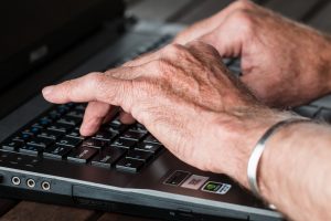Aged Hands on a Laptop