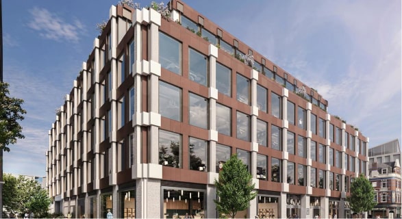 Modern office building with glass windows and trees under a clear blue sky.